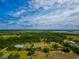 Wide aerial shot of a property with mature trees on a clear day at 6321 279Th E St, Myakka City, FL 34251