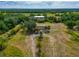 Wide aerial shot of a home and barn on a large lot with plentiful foliage and trees at 6321 279Th E St, Myakka City, FL 34251