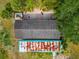 Aerial view of the property's roof, including a red brick patio with a dog and lush landscaping at 6321 279Th E St, Myakka City, FL 34251