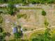Acreage featuring a small residence and verdant lawns, offering peaceful seclusion at 6321 279Th E St, Myakka City, FL 34251