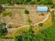 Vast lot showcasing a metal building and vehicle, surrounded by a winding path and tropical greenery at 6321 279Th E St, Myakka City, FL 34251