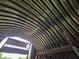 View looking up at the curved metal roof of the barn, highlighting its sturdy construction at 6321 279Th E St, Myakka City, FL 34251