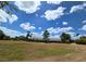Vast lot features a large metal barn, mature landscaping and a clear, sunny sky filled with clouds at 6321 279Th E St, Myakka City, FL 34251