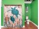 Cozy bathroom featuring a turtle themed shower curtain and matching toilet seat at 6321 279Th E St, Myakka City, FL 34251