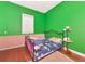 Bedroom features hardwood floors, a metal frame bed with side table and a window for natural light at 6321 279Th E St, Myakka City, FL 34251
