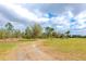 Acreage featuring mature trees and a long driveway leading to an unseen home at 6321 279Th E St, Myakka City, FL 34251
