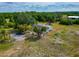 Aerial view of home, mature trees, and ample parking at 6321 279Th E St, Myakka City, FL 34251