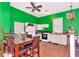 Inviting kitchen with bright green walls, white appliances, and an adjacent dining area at 6321 279Th E St, Myakka City, FL 34251