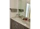 Bathroom featuring double sinks, gray cabinets, and a large mirror at 6368 Draw Ln # 34, Sarasota, FL 34238