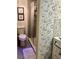 Well-lit bathroom showcasing a glass door shower and leaf patterned wallpaper at 6368 Draw Ln # 34, Sarasota, FL 34238