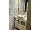 Stylish bathroom featuring a modern vessel sink and elegant wallpaper at 6368 Draw Ln # 34, Sarasota, FL 34238