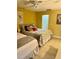Bright bedroom with tiled floors, two beds, and overhead ceiling fan at 6368 Draw Ln # 34, Sarasota, FL 34238
