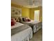 Bright bedroom with tiled floors, two beds, and overhead ceiling fan at 6368 Draw Ln # 34, Sarasota, FL 34238
