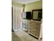 Comfortable bedroom with bright walls, tiled floor, dresser, and sliding glass door at 6368 Draw Ln # 34, Sarasota, FL 34238