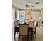 Cozy dining area with a wooden table, upholstered chairs, and an open layout into the kitchen at 6368 Draw Ln # 34, Sarasota, FL 34238