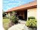 Inviting villa entrance with a well-kept walkway, vibrant shrubbery, and a terracotta roof at 6368 Draw Ln # 34, Sarasota, FL 34238