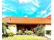Charming villa with a well-maintained lawn, vibrant flowers, and a distinctive terracotta roof at 6368 Draw Ln # 34, Sarasota, FL 34238