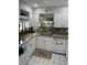 Charming kitchen with white cabinets, granite countertops, and stainless steel dishwasher at 6368 Draw Ln # 34, Sarasota, FL 34238