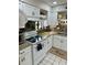 Well-lit kitchen featuring modern appliances, granite countertops, and white cabinetry at 6368 Draw Ln # 34, Sarasota, FL 34238