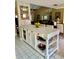 Stylish kitchen island featuring white cabinets, drawers, open shelving, and a beautiful countertop at 6368 Draw Ln # 34, Sarasota, FL 34238
