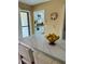 Kitchen island with seating, a view into kitchen and a decorative clock on the wall at 6368 Draw Ln # 34, Sarasota, FL 34238