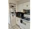 Cozy kitchen with white cabinets, granite countertops, stainless steel appliances, and unique backsplash at 6368 Draw Ln # 34, Sarasota, FL 34238