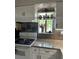 Bright kitchen with granite countertops, white cabinets, and a view from the window over the sink at 6368 Draw Ln # 34, Sarasota, FL 34238