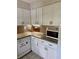 Modern kitchen featuring sleek granite countertops, a white dishwasher and classic white cabinets at 6368 Draw Ln # 34, Sarasota, FL 34238