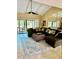 Bright living room featuring a large sectional sofa and sliding glass doors to the outdoors at 6368 Draw Ln # 34, Sarasota, FL 34238