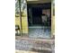 View of a patio with chairs and a table through sliding glass doors at 6368 Draw Ln # 34, Sarasota, FL 34238