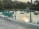 Tranquil swimming pool with ladder and nearby lounge chairs at 6368 Draw Ln # 34, Sarasota, FL 34238