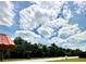 Scenic street view showcasing mature trees and blue sky with cloudy patterns at 6368 Draw Ln # 34, Sarasota, FL 34238