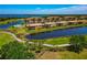 Stunning aerial view of condos alongside a golf course, surrounded by a tranquil lake at 6406 Grand Estuary Trl # 102, Bradenton, FL 34212