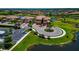 A beautiful home from an aerial view, situated on a corner lot near a pond and lush green landscaping at 6406 Grand Estuary Trl # 102, Bradenton, FL 34212