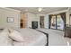 Open-concept bedroom with a walk-out to a deck, an ensuite bathroom, and a walk-in closet at 6406 Grand Estuary Trl # 102, Bradenton, FL 34212