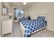 Charming bedroom featuring two beds, a ceiling fan, and a window for natural light at 6406 Grand Estuary Trl # 102, Bradenton, FL 34212