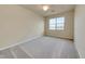 Bright and airy empty bedroom with a large window, neutral walls, and plush carpeting at 6406 Grand Estuary Trl # 102, Bradenton, FL 34212