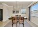 Formal dining room with four chairs at the table, modern light fixture, neutral walls and trim at 6406 Grand Estuary Trl # 102, Bradenton, FL 34212