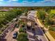 Gated community entrance featuring tile roof, brick pavers, and lush tropical landscaping at 6406 Grand Estuary Trl # 102, Bradenton, FL 34212