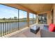 Serene screened patio with seating, offering beautiful views of the lake and golf course at 6406 Grand Estuary Trl # 102, Bradenton, FL 34212