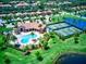 Aerial view of pool, tennis courts, and lush landscaping within a beautiful community at 6406 Grand Estuary Trl # 102, Bradenton, FL 34212