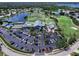 Aerial view of the Tara Golf and Country Club with lush green golf course, clubhouse, pool, and tennis courts at 6612 Butlers Crest Dr, Bradenton, FL 34203