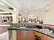 Wet bar with dark countertop, wine fridge, stainless steel sink and beer tap at 6612 Butlers Crest Dr, Bradenton, FL 34203
