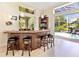 Entertain in a bar with a wood counter, and views of the outside screened in pool at 6612 Butlers Crest Dr, Bradenton, FL 34203