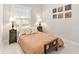 Cozy bedroom features neutral colored bedding, decorative side tables and ornate wall art at 6612 Butlers Crest Dr, Bradenton, FL 34203