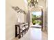 An inviting home foyer featuring elegant decor and an open view to the landscaped front yard at 6612 Butlers Crest Dr, Bradenton, FL 34203
