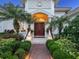 Elegant entrance featuring a double door, complemented by lush landscaping and classic architectural details at 6612 Butlers Crest Dr, Bradenton, FL 34203