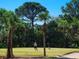 Golfers putting on the green at Tara Golf & Country Club, surrounded by mature landscaping at 6612 Butlers Crest Dr, Bradenton, FL 34203