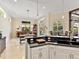 Open concept kitchen with a bar, black countertop island, bar seating, and breakfast nook at 6612 Butlers Crest Dr, Bradenton, FL 34203