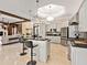 Open kitchen featuring an island with bar seating and stainless appliances with connection to the living room at 6612 Butlers Crest Dr, Bradenton, FL 34203